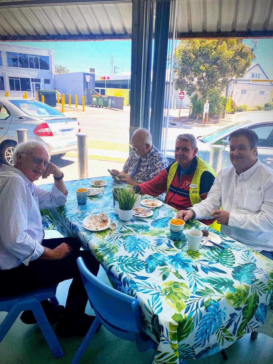 People sharing a meal at a table by the window